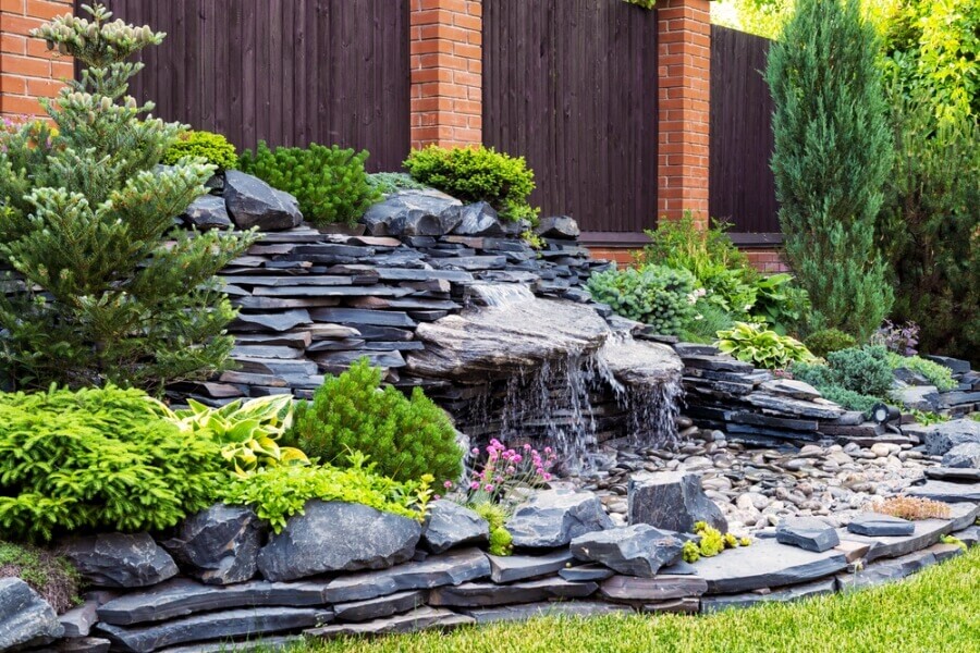 Landscaped yard with waterfall